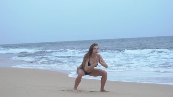 Een mooi meisje in bikini, treinen, op het strand, Indische Oceaan — Stockvideo