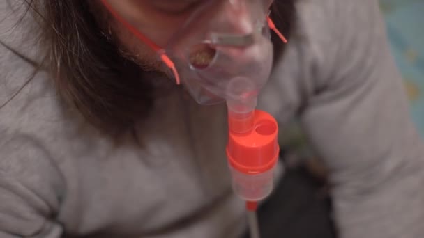 Kerl ist krank, macht medizinische Eingriffe, therapeutische Inhalation, schaut in Smartphone-Nachrichten zu — Stockvideo