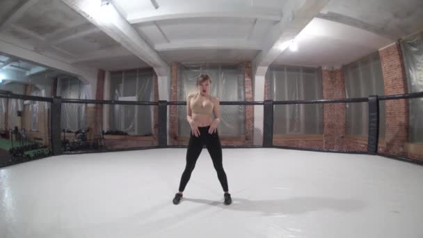 Beautiful woman with long hair in black clothes, dances a beautiful sexy dance in a octagon — Wideo stockowe