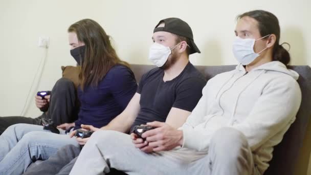 Four guys during quarantine, playing video games at home, self-isolation — Stock Video