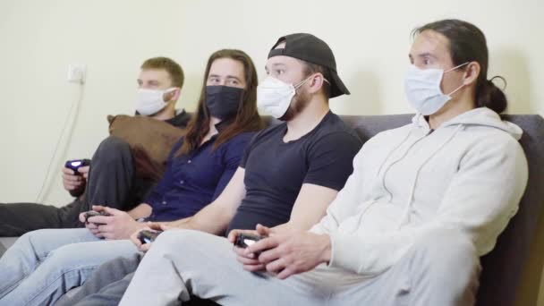 Four guys playing video games at home, during the epidemic of coronavirus, rest laugh fun — Stock Video