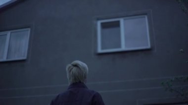 The girl, a blonde with a short haircut, is calling someone, and then shows the middle finger, fuck you