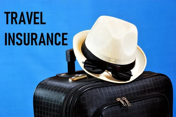 Travel insurance-provides financial well-being in life situations. Inscription text on the background of Luggage: suitcase, hat, glasses. Insurance policy is a registered document confirming the conclusion of the contract.