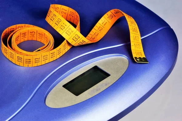 Scales and centimeters-control figures, weight in fitness. Obesity, weight management and healthy eating. Attractive figure is a sports workout regular exercise and medical supervision.