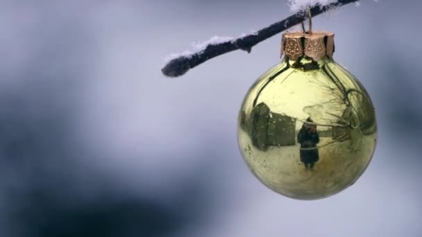 Close Green Christmas Ball Hanging Tree Brunch Snowy Weather Background — Stock Video