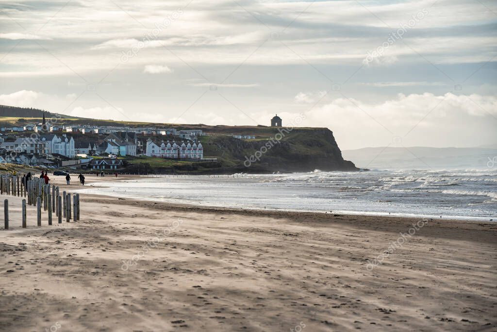 The beach at Castlerock in Northern Ireland.  The Mussenden Temple can be seen at the top of the sea cliff in the distance