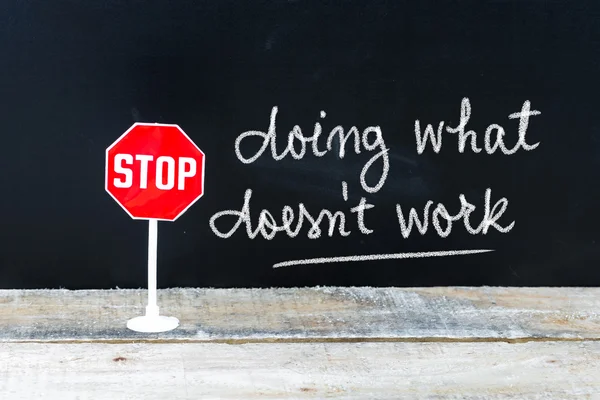 STOP DOING WHAT DOES NOT WORK message written on chalkboard — Stock Photo, Image