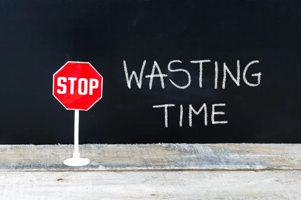 STOP WASTING TIME message written on chalkboard — Stock Photo, Image