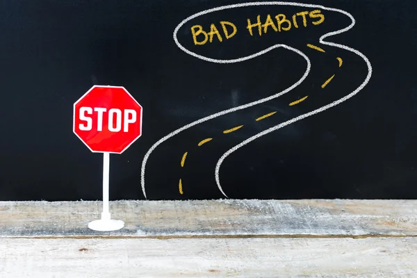 Mini STOP sign on the road to BAD HABITS — Stock Photo, Image