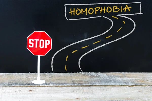 Mini STOP sign on the road to HOMOPHOBIA — Stock Photo, Image