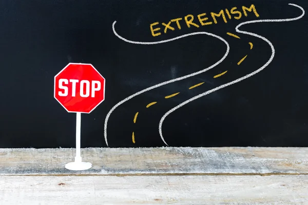 Mini STOP sign on the road to EXTREMISM — Stock Photo, Image