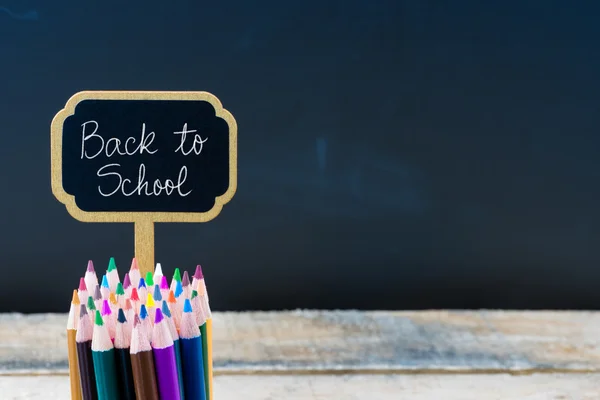 Wooden mini blackboard label with message Back To School — Zdjęcie stockowe