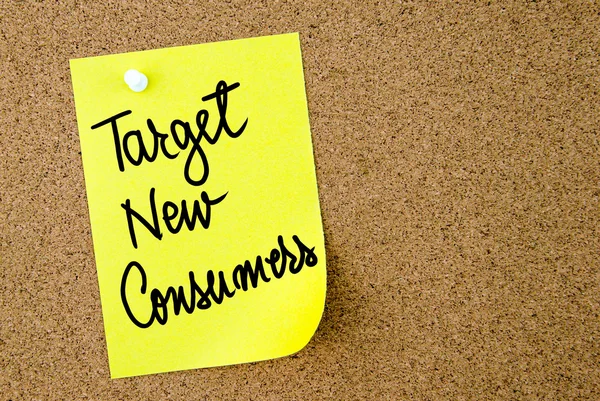 Target New Consumers text written on yellow paper note — Stock Photo, Image