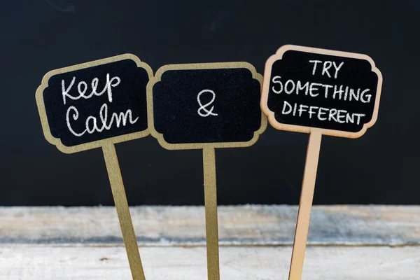 Keep Calm and Try Something Pesan yang berbeda ditulis dengan kapur pada label papan tulis mini — Stok Foto