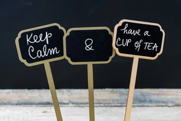Keep Calm and Have a cup of Tea message written with chalk on mini blackboard labels — стоковое фото
