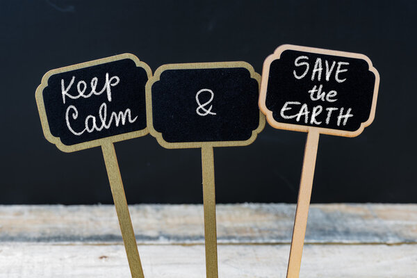 Keep Calm and Save The Earth message written with chalk on mini blackboard labels
