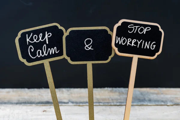 Keep Calm and Stop Worrying message written with chalk on mini blackboard labels — Stock Photo, Image