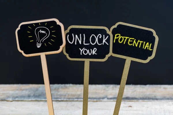 Concept message UNLOCK YOUR POTENTIAL and light bulb as symbol for idea — Stock Photo, Image