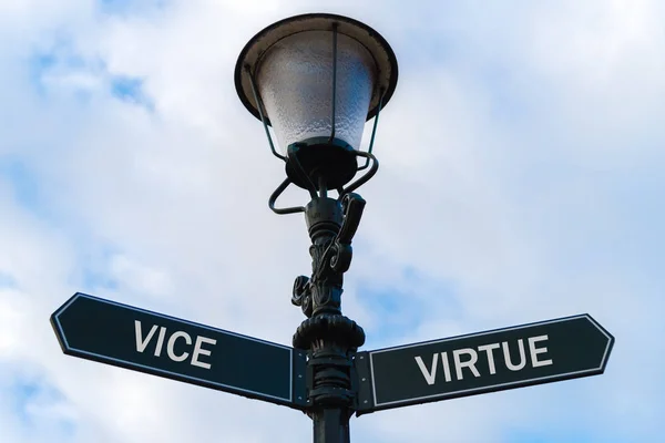 Vice versus Virtue directional signs on guidepost — Stock Photo, Image