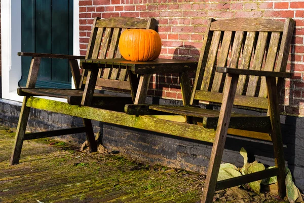 Pumpkin standing on vintage wooden table — Stock Photo, Image