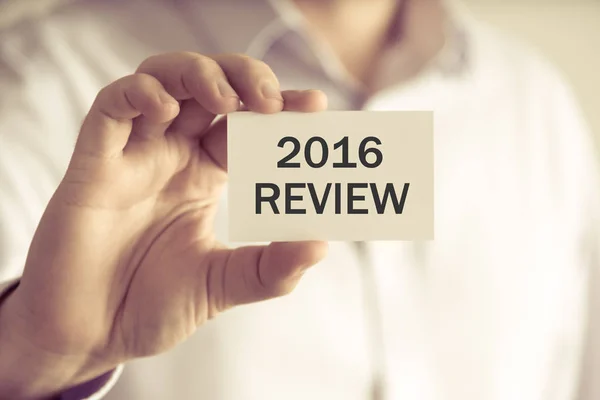 Businessman holding 2016 REVIEW message card — Stock Photo, Image
