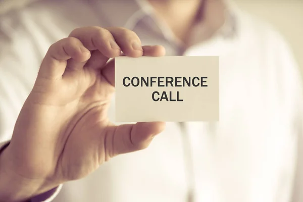 Businessman holding CONFERENCE CALL message card — Stock Photo, Image