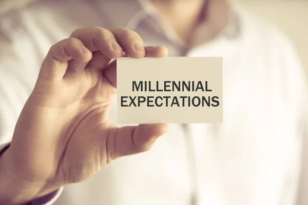 Businessman holding MILLENNIAL EXPECTATIONS message card — Stock Photo, Image