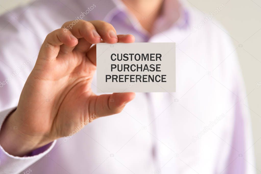 Businessman holding a card with text CUSTOMER PURCHASE PREFERENCE