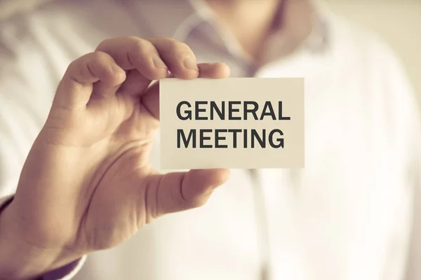 Businessman holding GENERAL MEETING message card — Stock Photo, Image