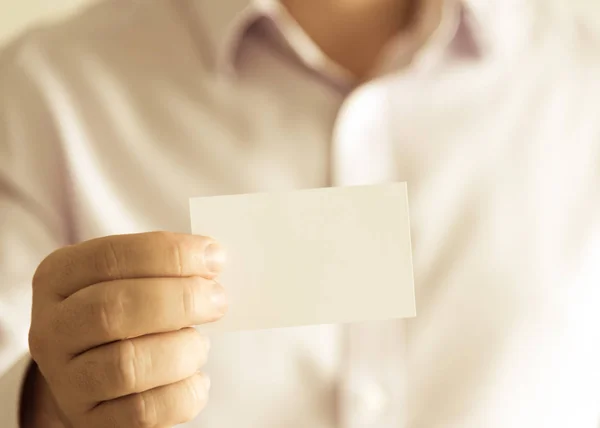 Businessman holding empty message card with copy space for text