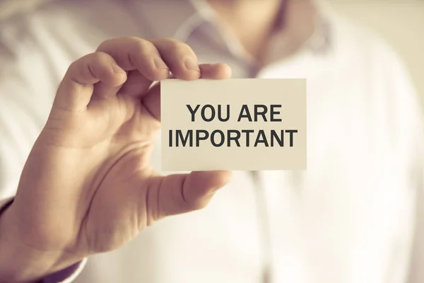 Businessman holding YOU ARE IMPORTANT message card — Stock Photo, Image