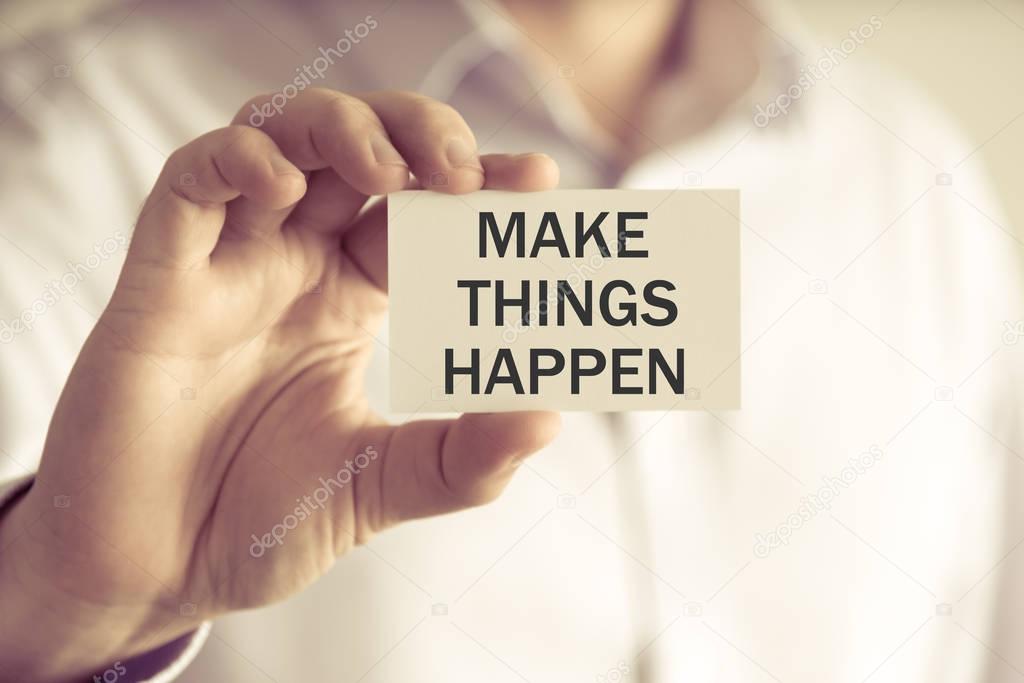 Businessman holding MAKE THINGS HAPPEN message card