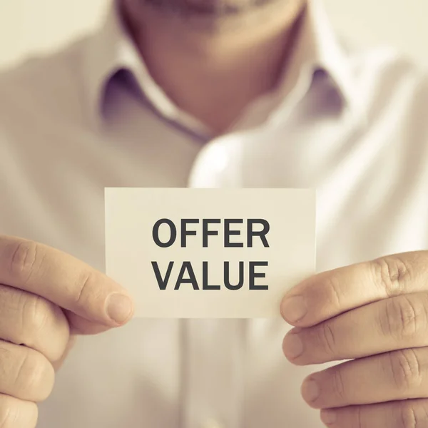Businessman holding OFFER VALUE message card — Stock Photo, Image