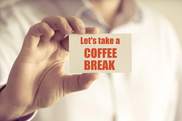 Businessman holding LETS TAKE A COFFEE BREAK message card — Stock Photo, Image