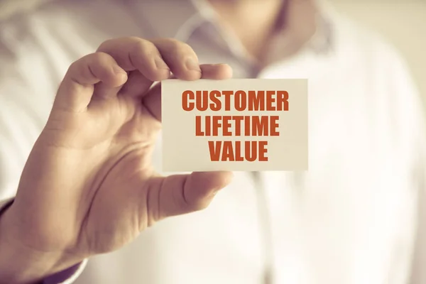 Businessman holding CUSTOMER LIFETIME VALUE message card — Stock Photo, Image