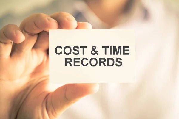 Businessman holding COST AND TIME RECORDS message card — Stock Photo, Image
