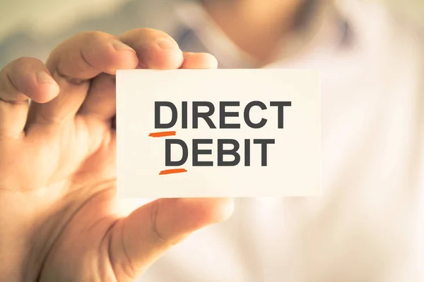 Businessman holding card with DD DIRECT DEBIT acronym text — Stock Photo, Image