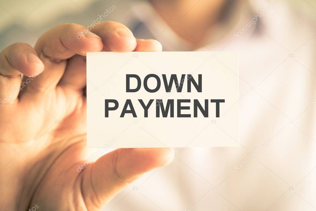 Businessman holding DOWN PAYMENT message card