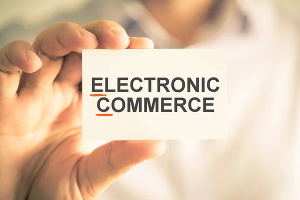 Businessman holding card with EC ELECTRONIC COMMERCE acronym text — Stock Photo, Image