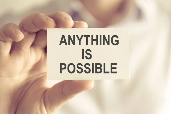 Businessman holding ANYTHING IS POSSIBLE message card — Stock Photo, Image