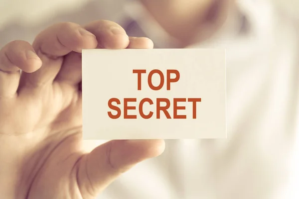 Businessman holding TOP SECRET message card — Stock Photo, Image