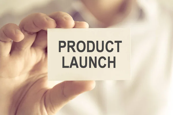 Businessman holding PRODUCT LAUNCH message card