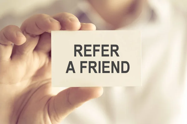 Businessman holding REFER A FRIEND message card — Stock Photo, Image