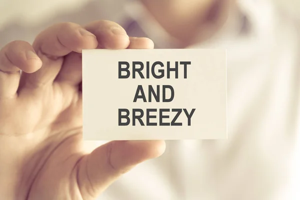 Businessman holding BRIGHT AND BREEZY message card — Stock Photo, Image