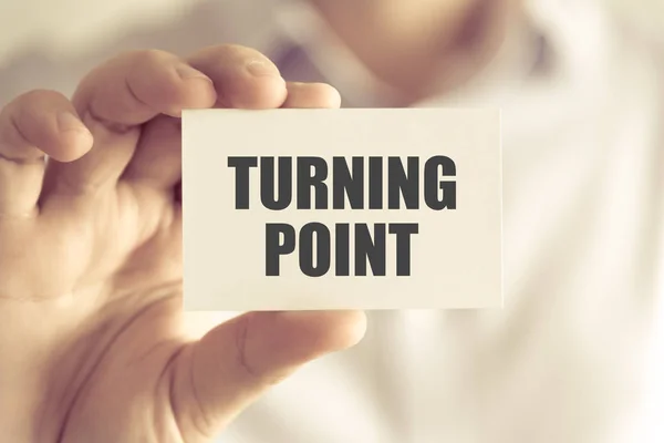 Businessman holding TURNING POINT message card