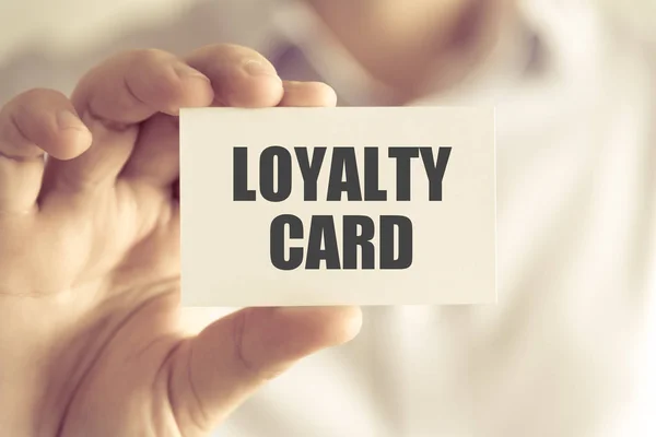 Businessman holding LOYALTY CARD message card