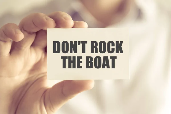 Businessman holding DONT ROCK THE BOAT message card — Stock Photo, Image