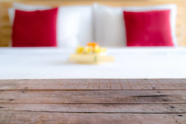 Perspective empty wooden table in front of blurred hotel room — Stock Photo, Image