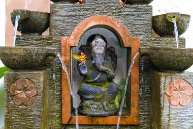 Traditional fountain with statue of Ganesha in Ubud, Bali clipart