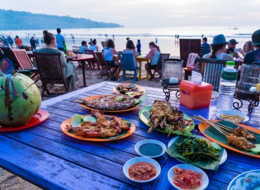 Sea food restaurants on Jimbaran beach in Bali, Indonesia clipart